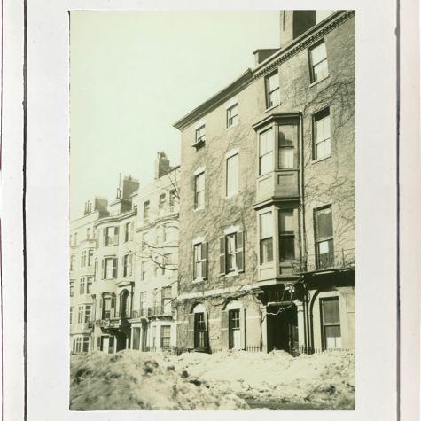 A sepia-toned image of a row of four-story residential buildings on Mt. Vernon Street in Boston, taken in March 1920. The buildings are in the background; a large snowbank is in the foreground.